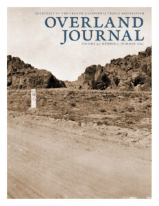cover of Overland Journal with text and image of dirt road, mile marker an rocky landscape